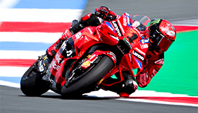 Ducati MotoGP rider leaning into a corner on track